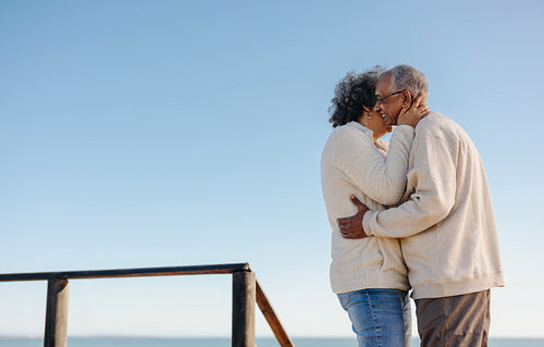 Mature lovebirds being romantic at the beach