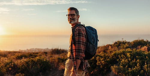 Happy male hiker smiling at the camera outdoors