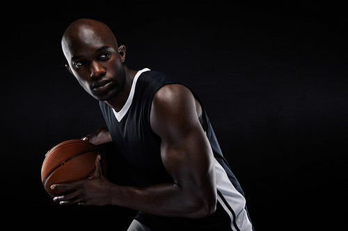 Young basketball player looking away
