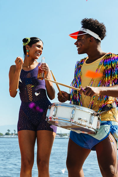 Two friends celebrate carnival by the sea