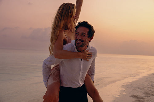 Sunset elopement: Happy couple celebrating love and togetherness on a tropical beach