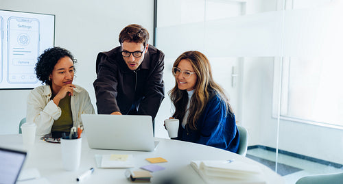 Three designers work together on UX ideas