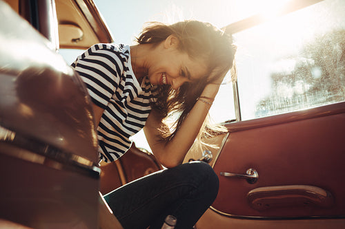 Woman sitting in the car and laughing