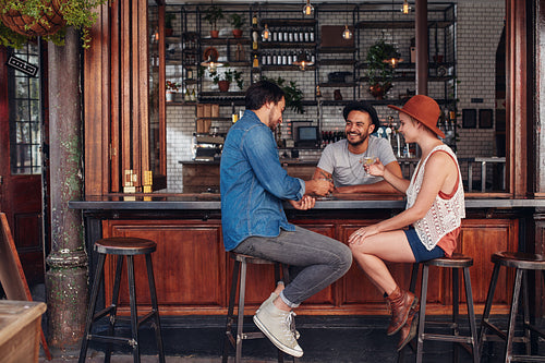 Group of friends sitting and talking at a cafe