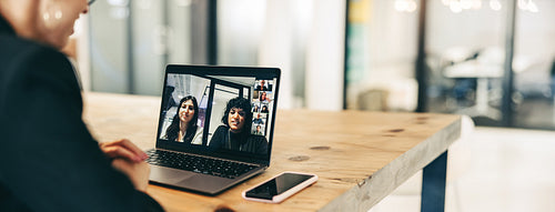 Young businesswoman attending a virtual meeting in a modern office