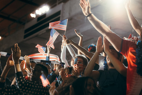 US football supporters in fan zone watching a match