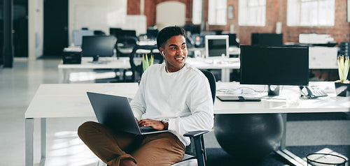 Young programmer smiling in a modern office