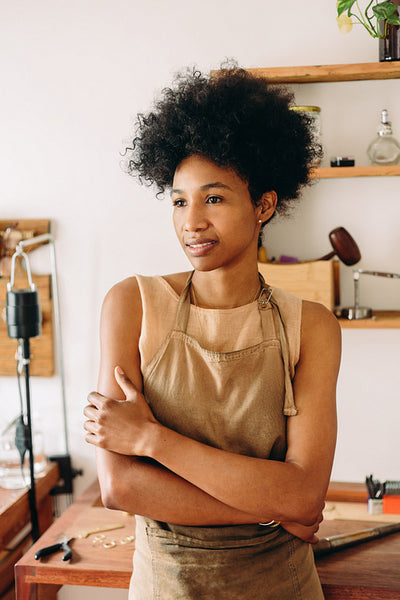 Confident female jeweler looking away