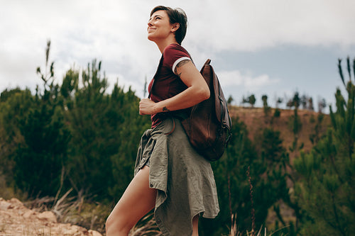 Female explorer walking through a forest