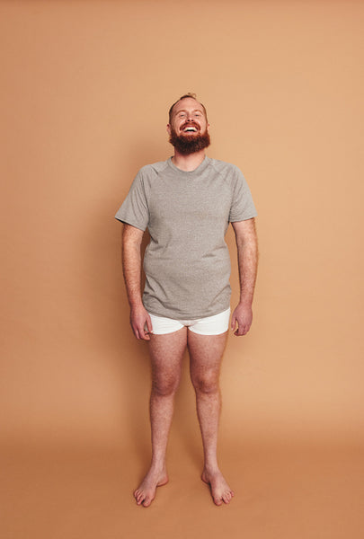 Studio portrait of a happy man standing alone