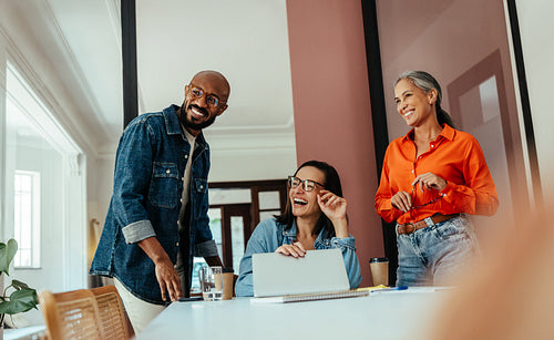 Creatives and freelancers collaborating in a modern, colorful office boardroom