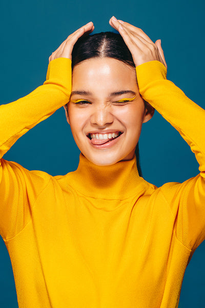 Self-expression through makeup: Radiant young woman celebrates her beauty in a studio