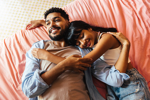 Father and daughter bonding while relaxing on a cozy bed at home