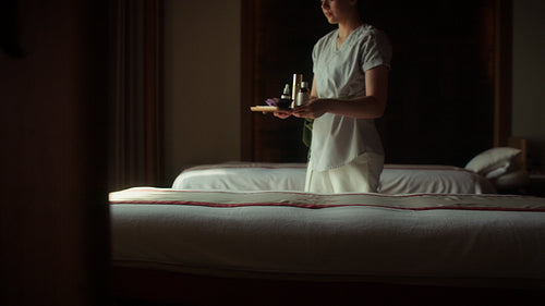 Professional spa therapist prepares a tranquil massage room for a relaxing wellness treatment