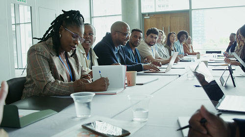 Diverse colleagues laughing in office conference