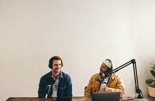 Male podcaster interviewing a guest on his show