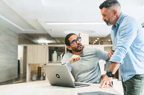 Two businessmen working together in a co-working space