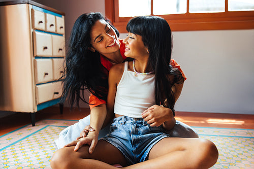 Loving mother and daughter sharing quality time together indoors