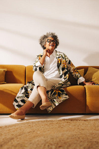 Senior businesswoman looking away with a smile in an office lobb