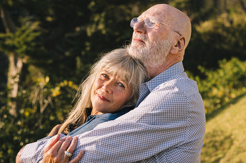 Senior couple embracing each other in a park