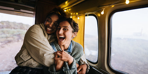 Friends on a joyful road trip in a camper van