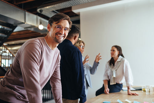 Professional man having a meeting with his team in an office