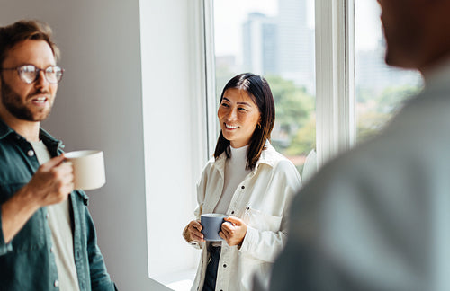 Business people having a chat during a coffee break in an office