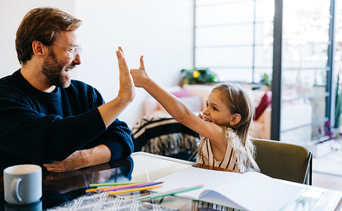 Father and daughter share a high five