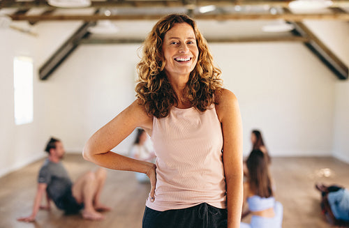 Mature woman standing in a fitness studio