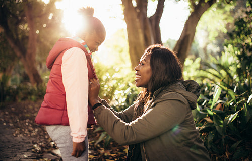 Mother and daughter smiling outdoors