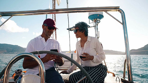 Loving mature couple enjoying wine on yacht