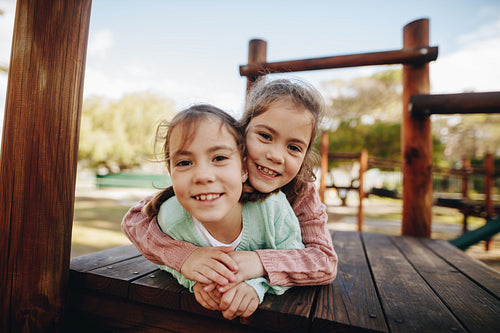 Beautiful little twin girls enjoying at playground