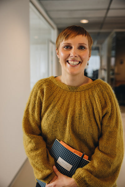 Cheerful entrepreneur standing in office