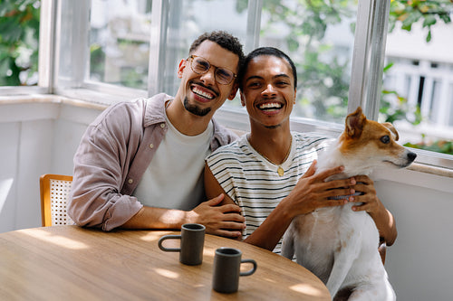Young couple with their dog enjoying time together at home
