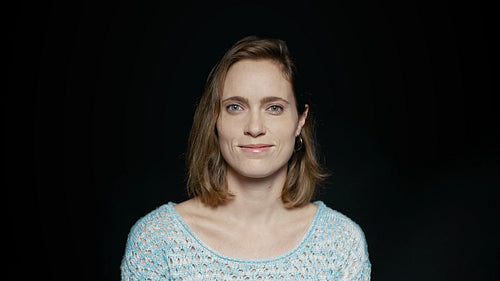 Beautiful woman smiling on black background