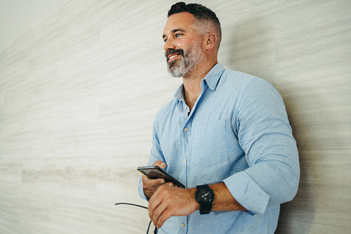 Happy businessman smiling while standing in an office