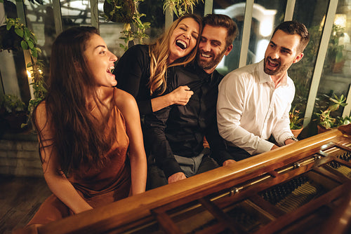 Carefree friends singing and laughing together