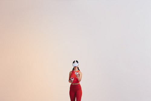 Young woman playing a virtual reality game