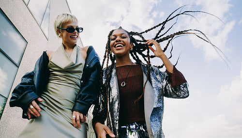 Shared laughter outdoors: friends enjoying the city together