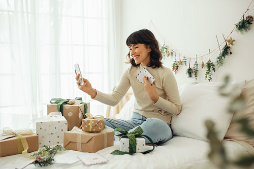 Woman celebrating christmas with friends over video call