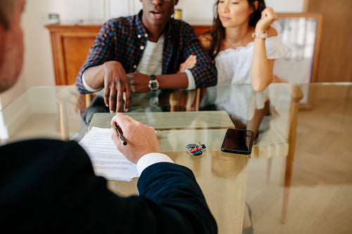 Couple and estate agent discussing during a property deal