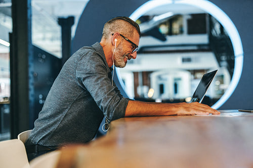 Experienced businessman smiling during a virtual meeting