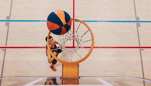 Eyes on the prize: Female player aims for the hoop with determination