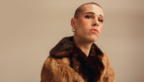 Handsome young man in a fur coat