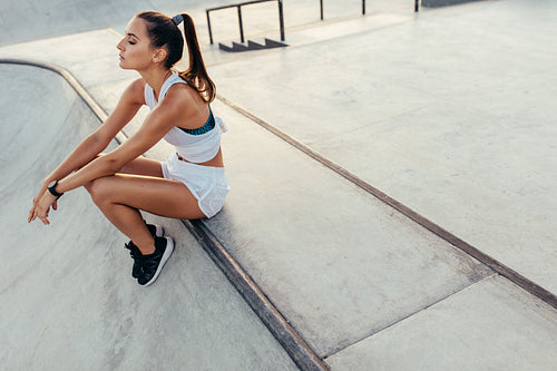 Woman sitting and relaxing after physical training