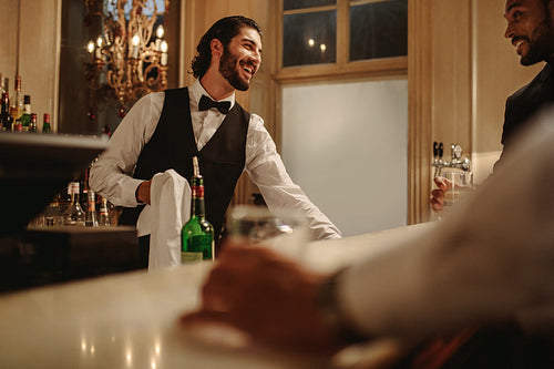 Bartender talking with guest at a nightclub