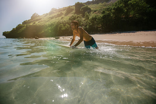 Man surfing in the ocean water with surf board