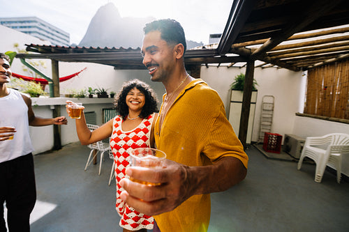 Group of friends enjoying drinks on a rooftop patio in Rio de Janeiro