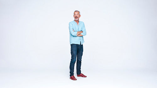 Senior man standing with arms crossed