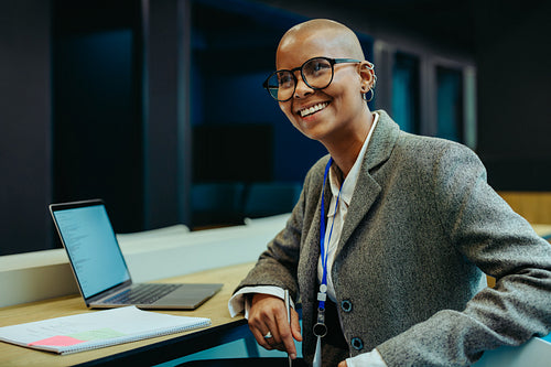 Confident female finance professional smiling at her workspace